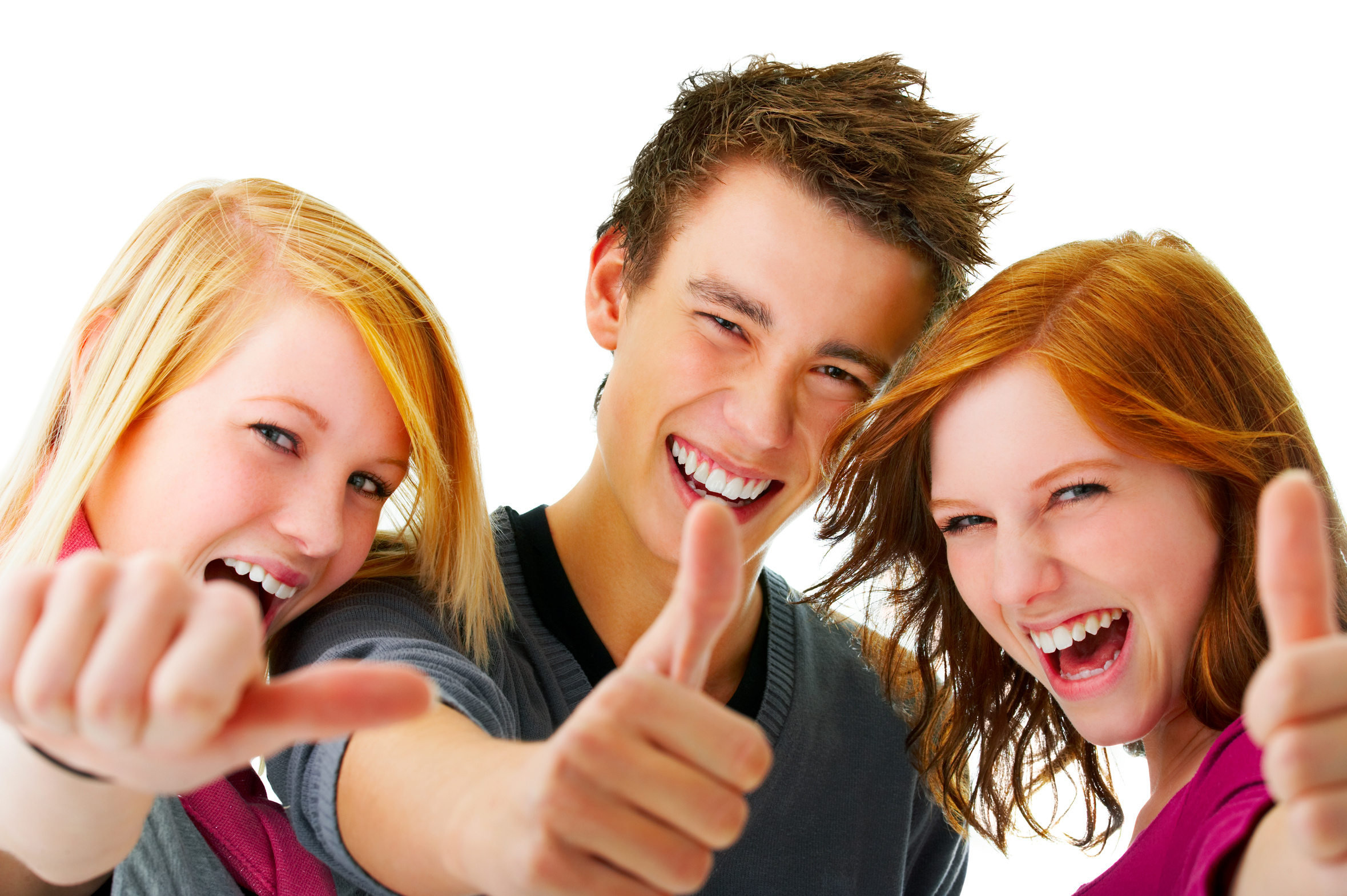 Portrait of three young teenagers laughing and giving the thumbs-up sign.